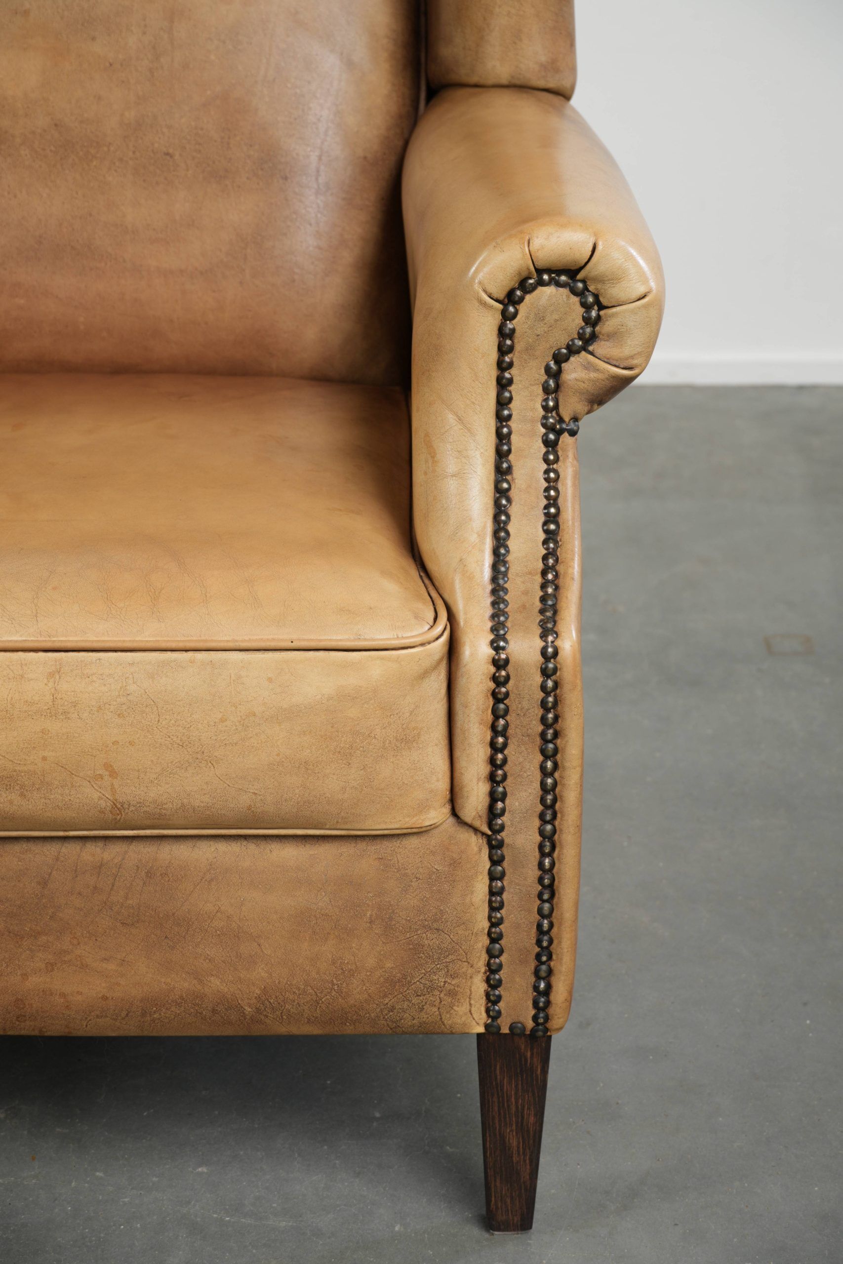 Comfortable cowhide wingback armchair with a timeless English look