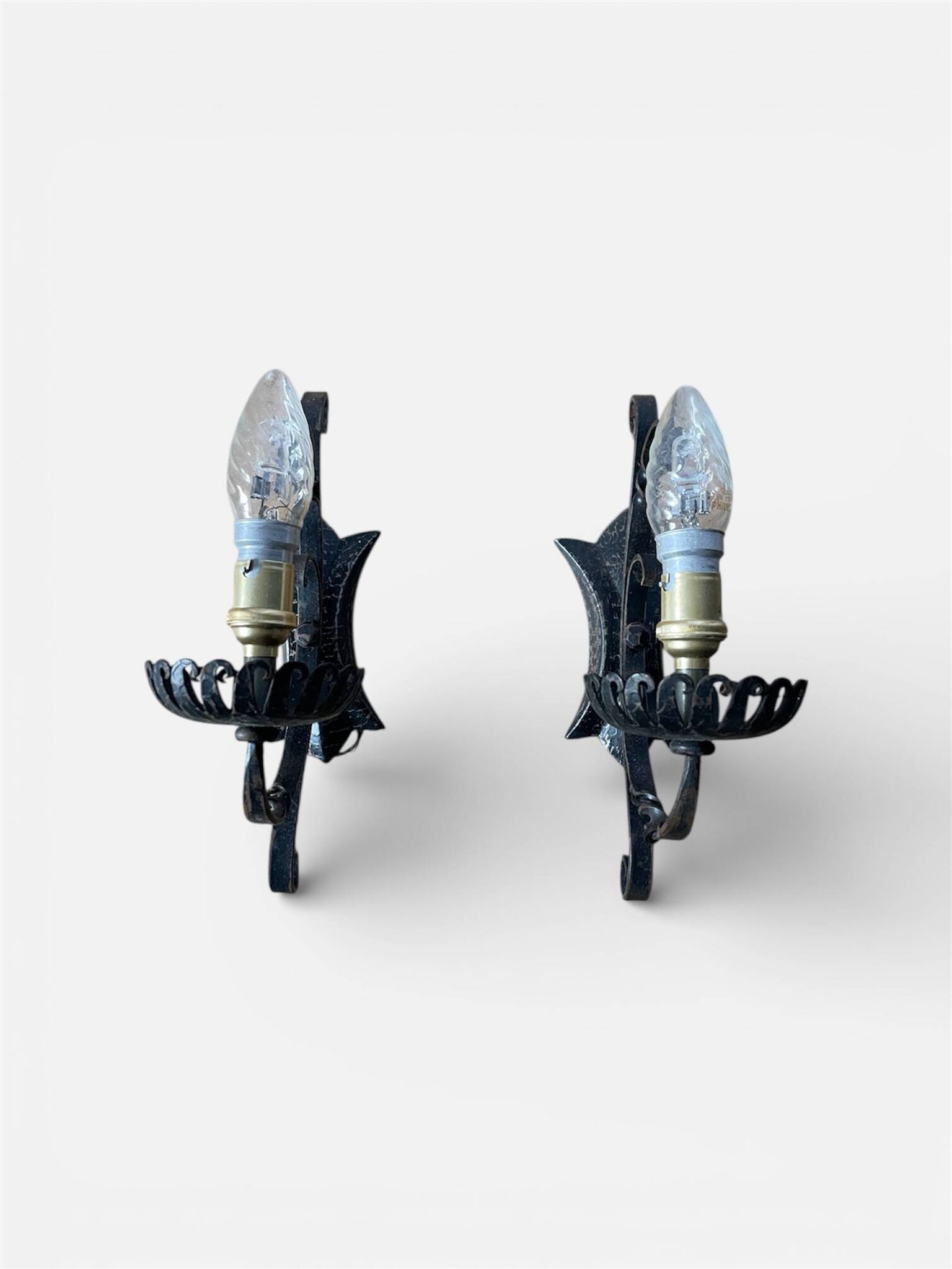 Vintage wrought iron wall lights in rustic gothic style.