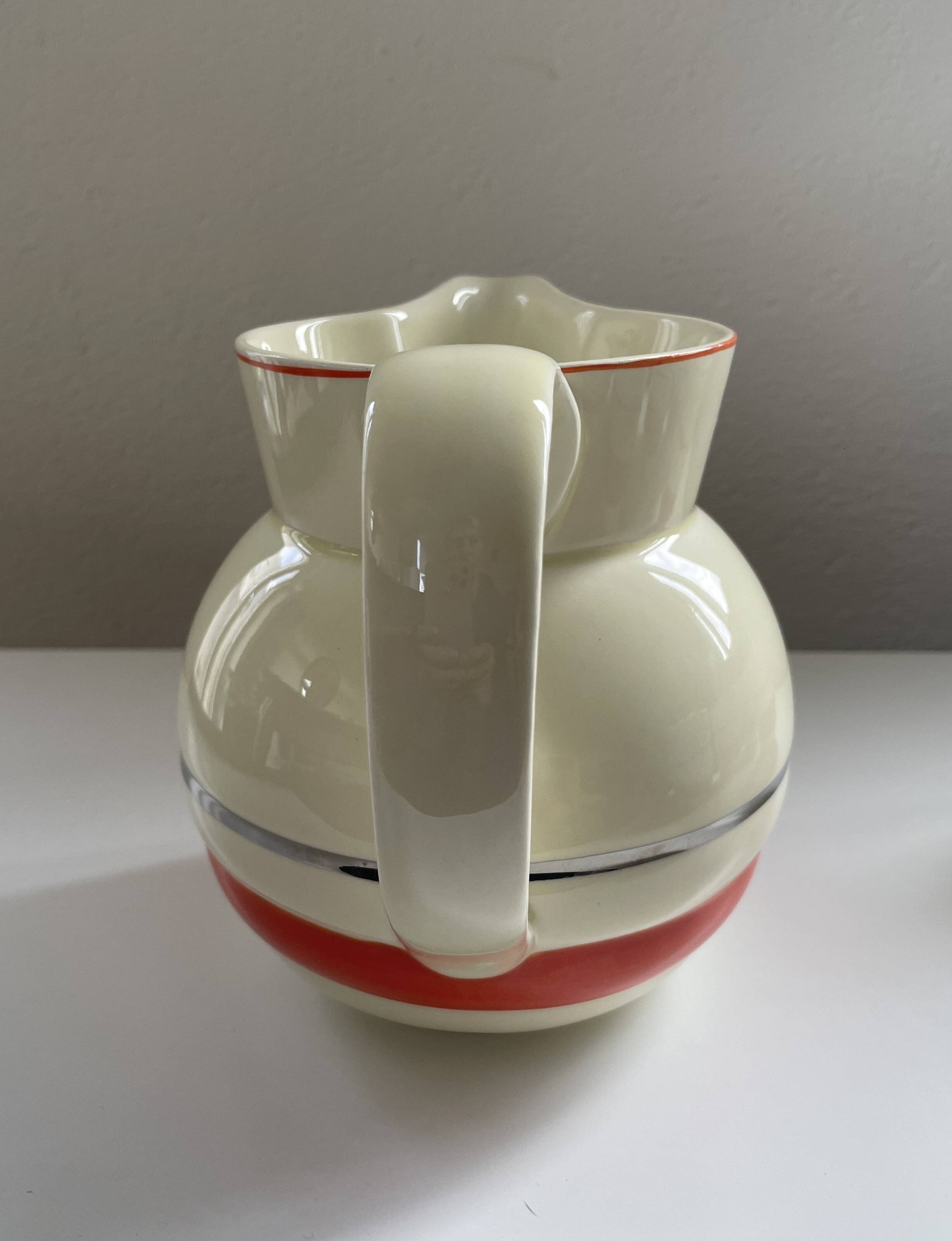 Red, white and silver porcelain jug set by Edmond Bellefroid for Robo.
