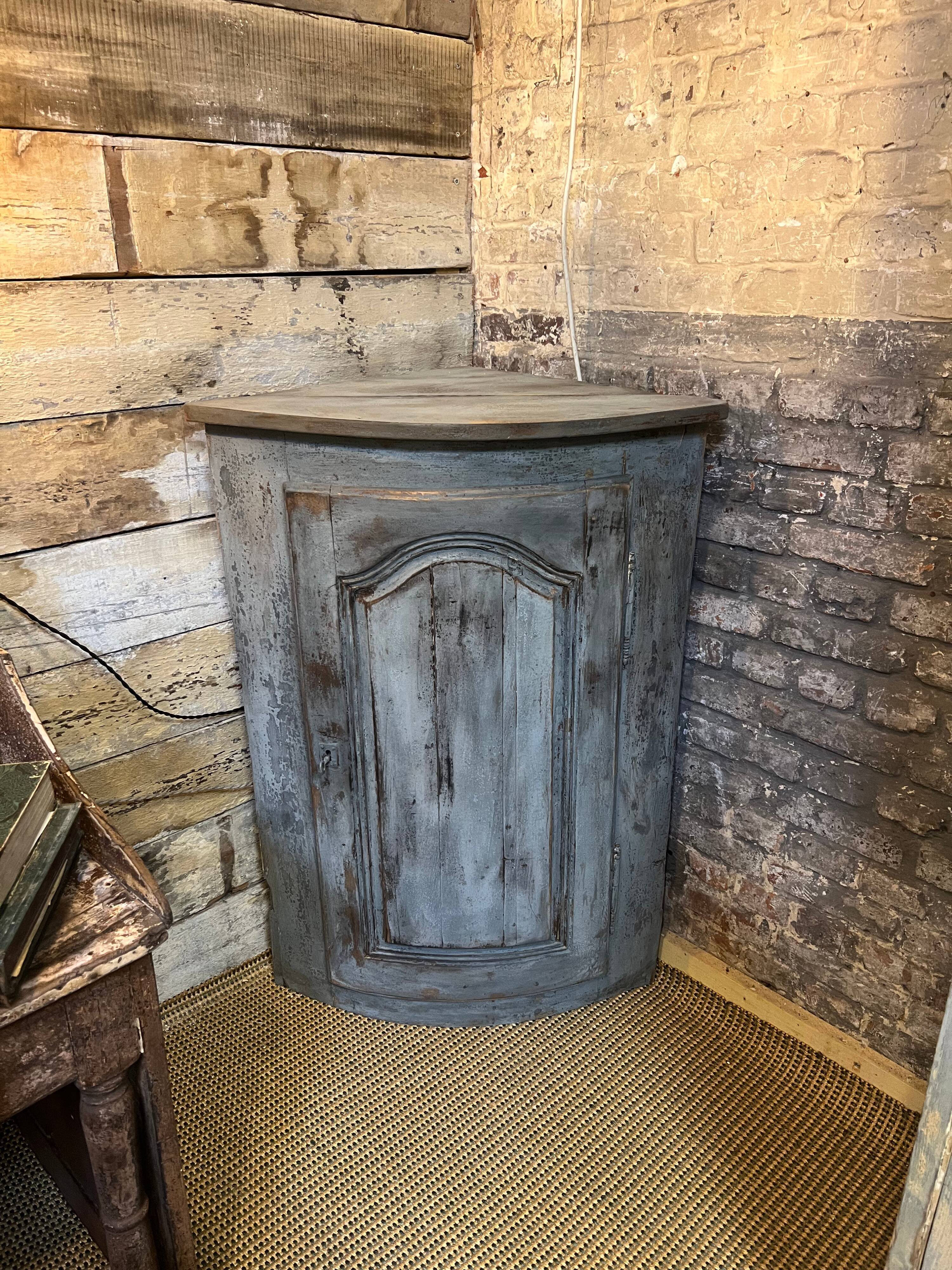 Eighteenth-century corner cabinet with a patina.