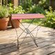 Vintage folding stool with a bayadère fabric pattern.