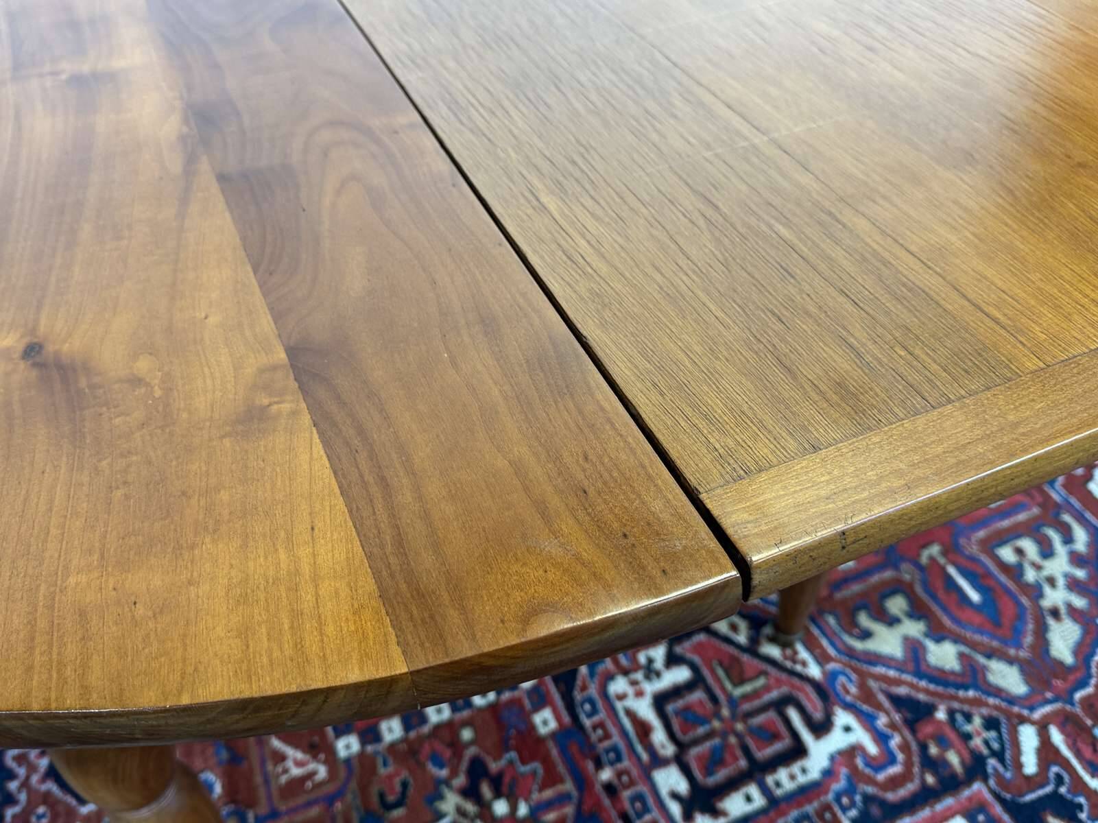 Round cherry wood table, 6 feet, Louis Philippe style with 2 extensions.
