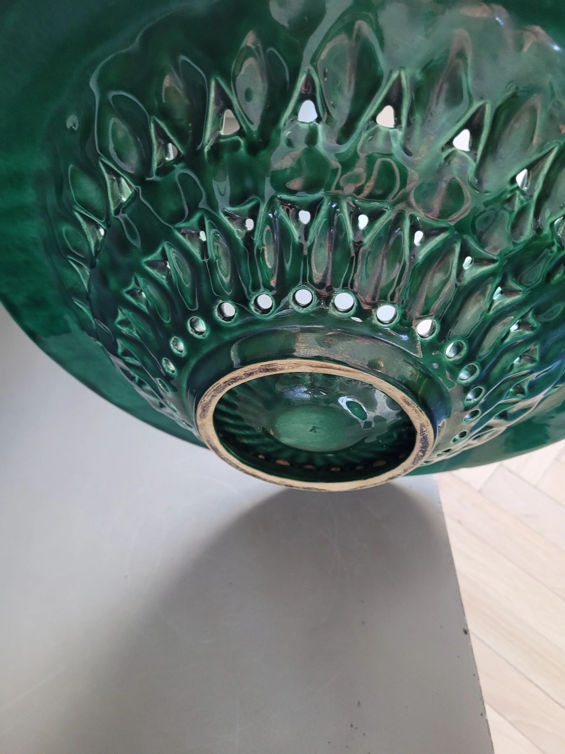 Large pierced earthenware fruit bowl glazed in green and gold.