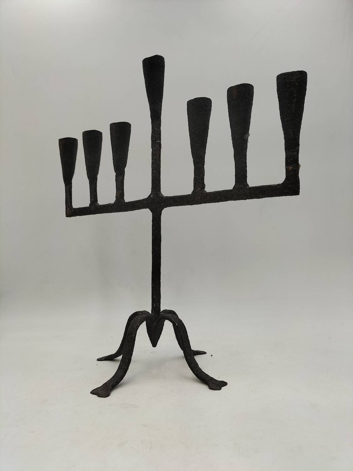Brutalized wrought iron candle holder