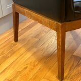 Modernist armchair in wood and black synthetic leather, circa 1960