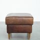 Sturdy vintage sheepskin ottoman in a beautiful large size with black piping