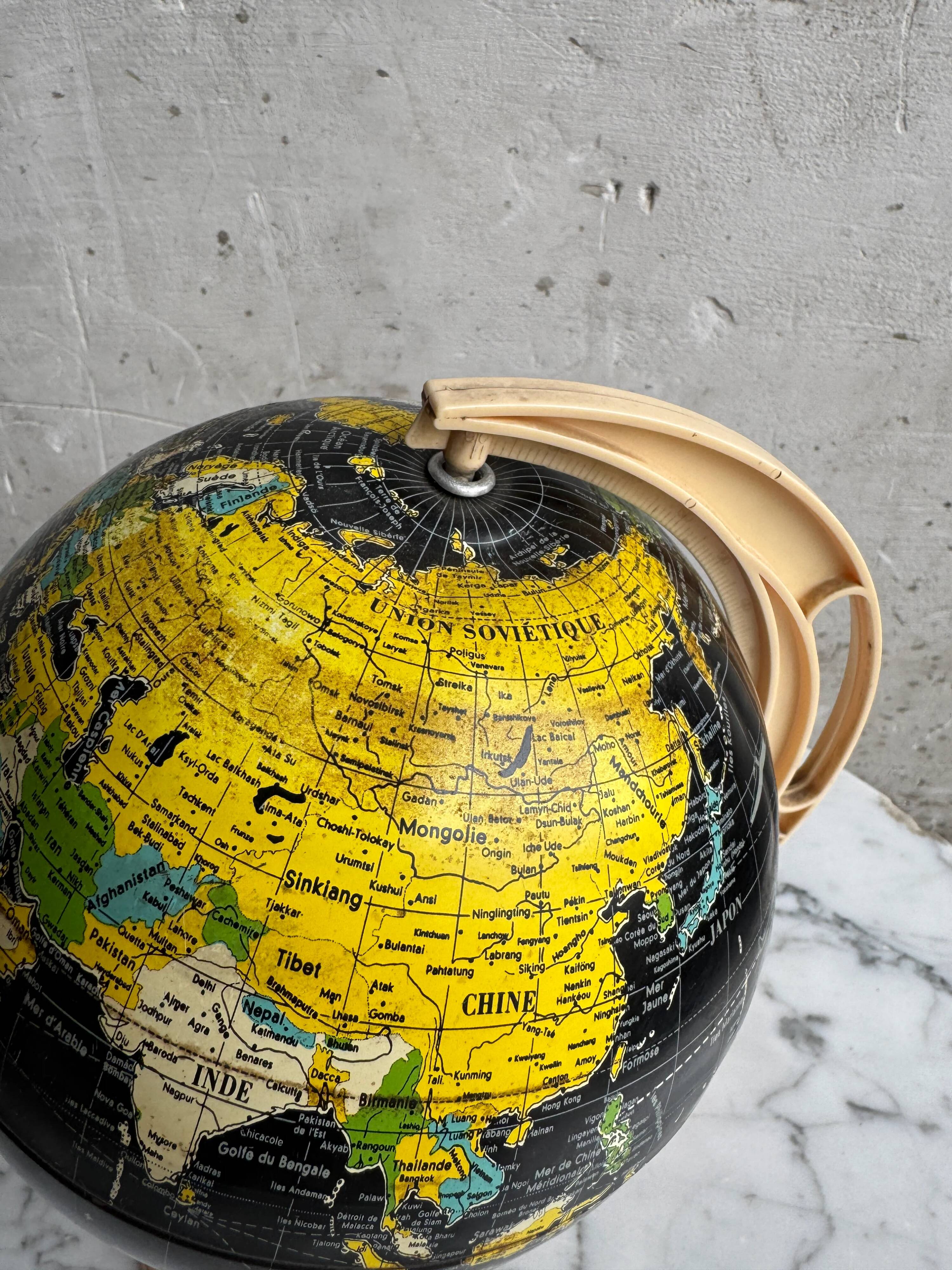 French mid-century school globe with black oceans on printed paper, cream plastic base