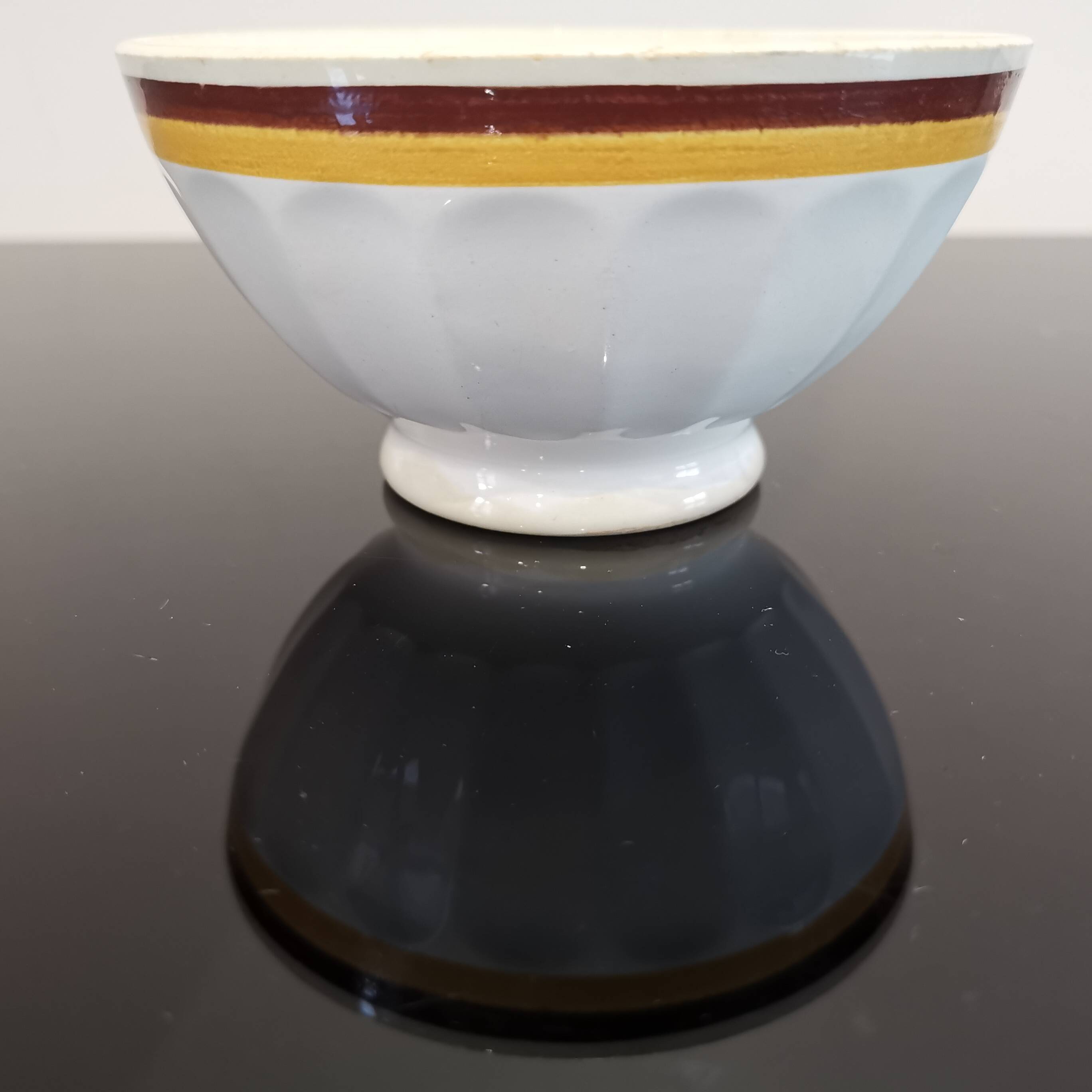 Authentic Vintage ceramic faceted bowl decorated with a double border