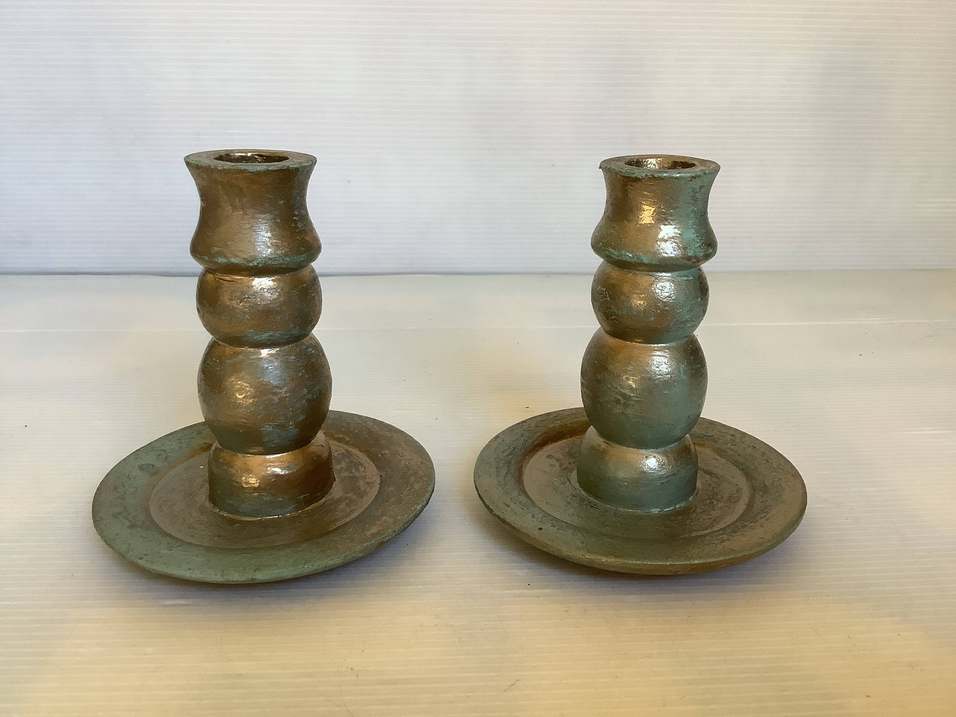 Pair of green and gold wooden candlesticks