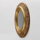 French Baroque style oval mirror in gilded wood with floral decorations