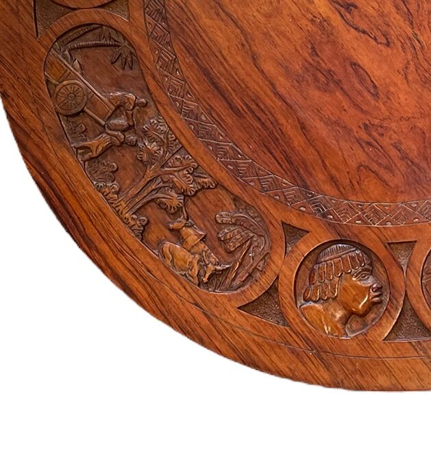 Circular tripod coffee table in carved wood