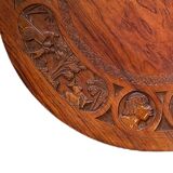 Circular tripod coffee table in carved wood