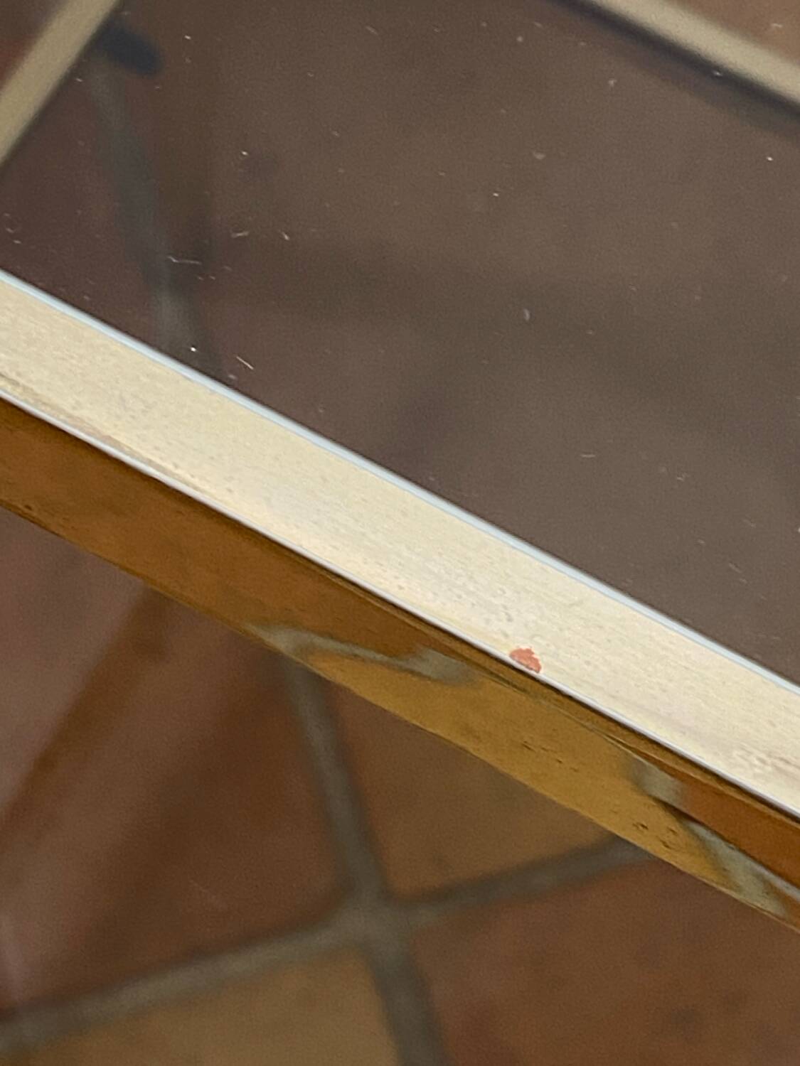 Gold metal and smoked glass console table.