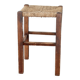 Rustic old stool made of wood and straw.