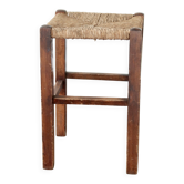 Rustic old stool made of wood and straw.