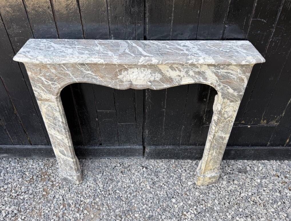 Louis XV fireplace in grey Ardennes marble, a floral basket in white marble, late 18th century.