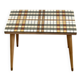 Small mosaic bedside table with tapered legs.