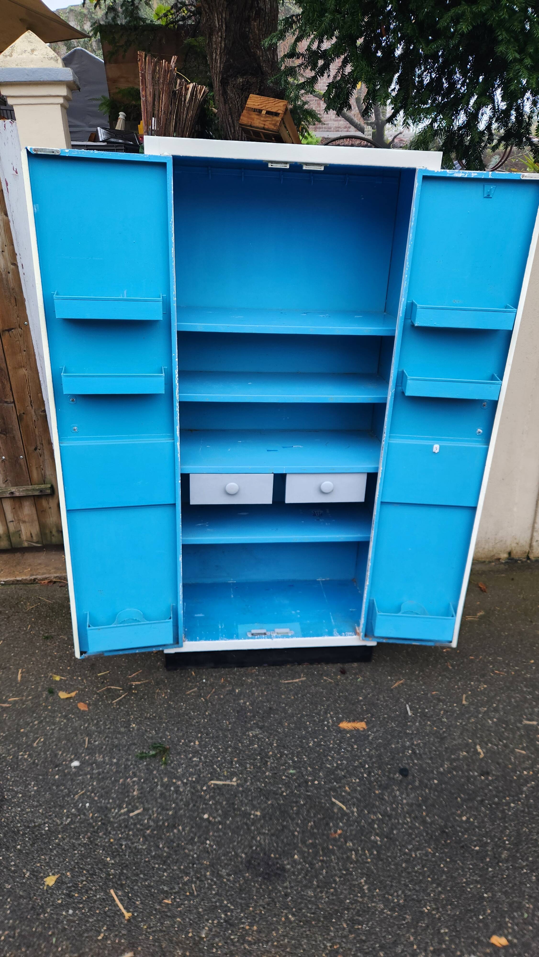Old industrial metal cabinet in white and blue.