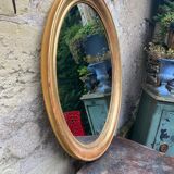 Golden oval mirror