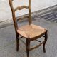 Solid oak carved chair with rush seating, Louis XV style, 19th century.
