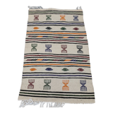 White carpet with multicolored Berber patterns woven hands
