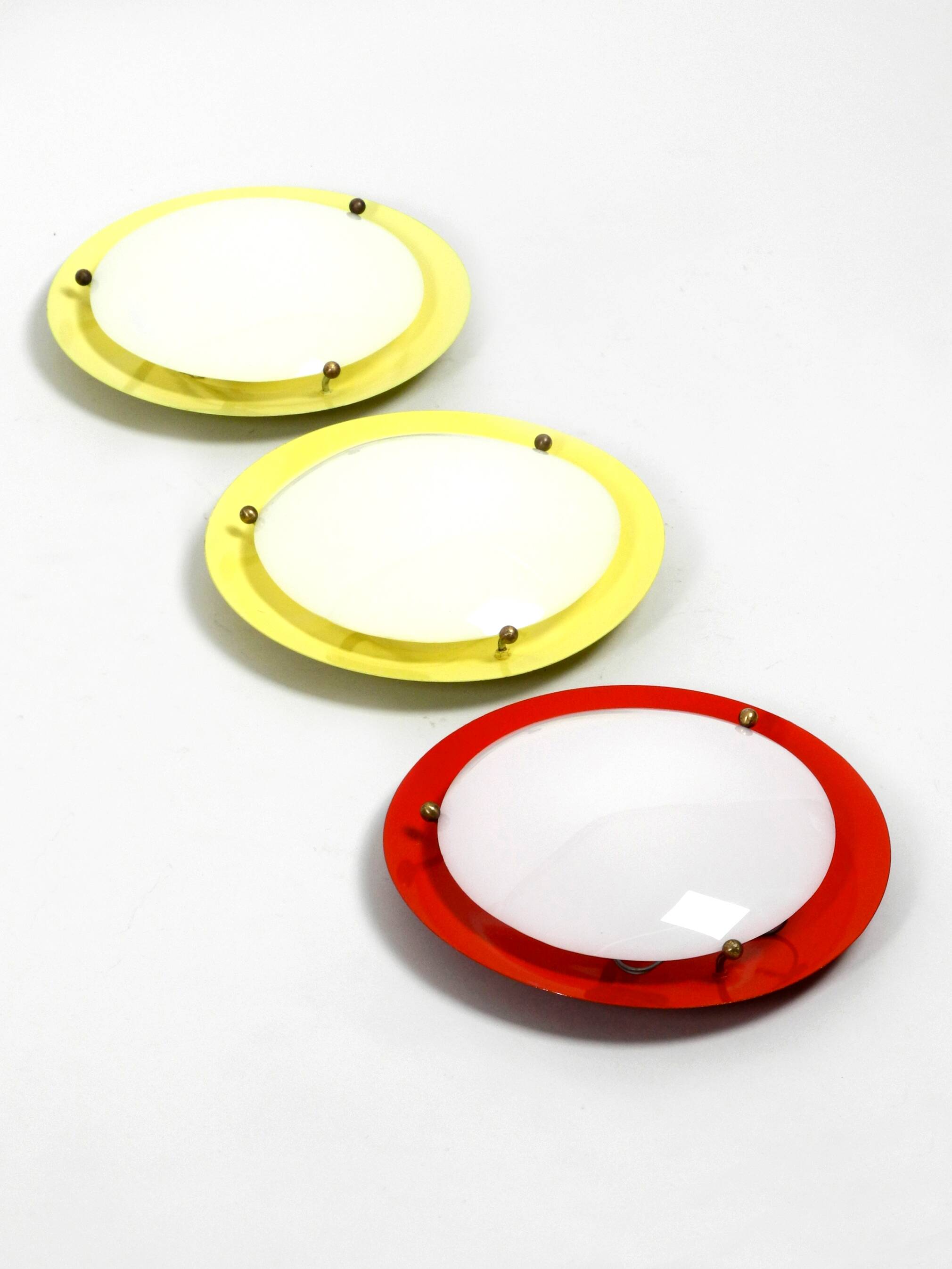 Three round 1950s wall or ceiling lamps made of metal and plexiglass shades