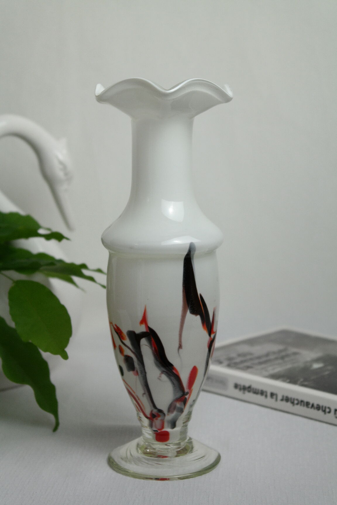 Corolla vase in white opaline with orange-brown patterns.