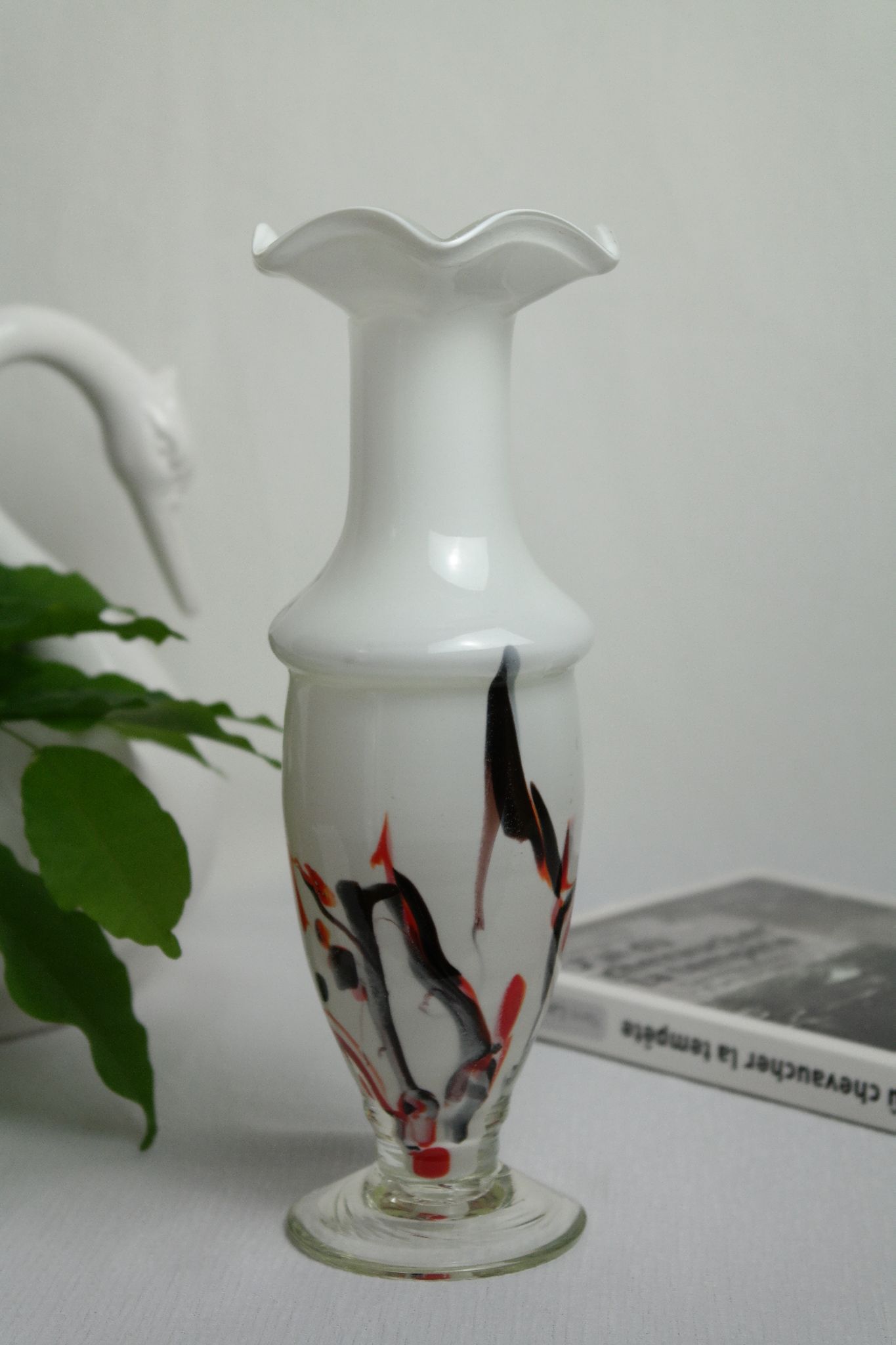 Corolla vase in white opaline with orange-brown patterns.