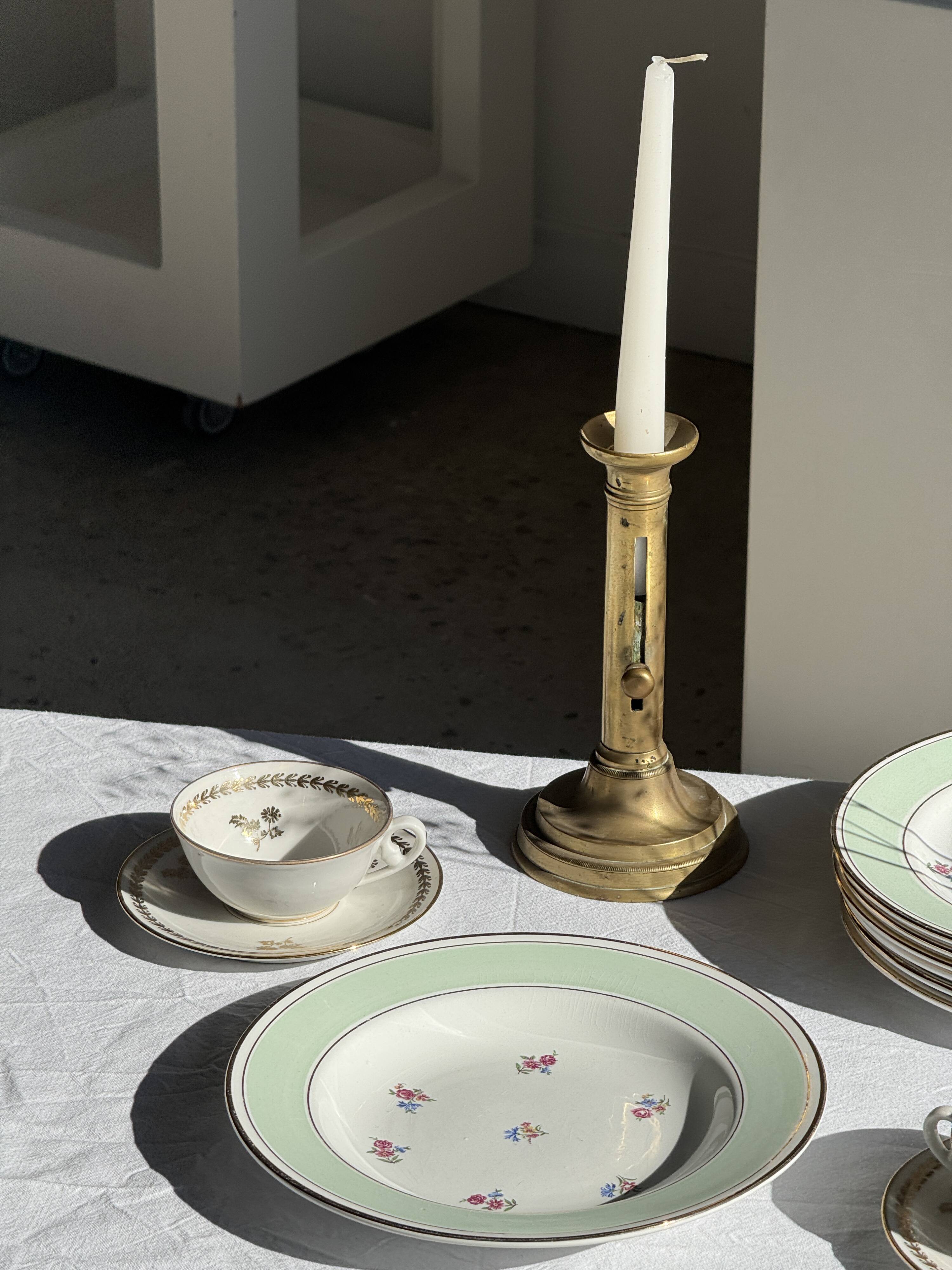 Set of 9 vintage turquoise deep plates with gold trim and pink flowers.