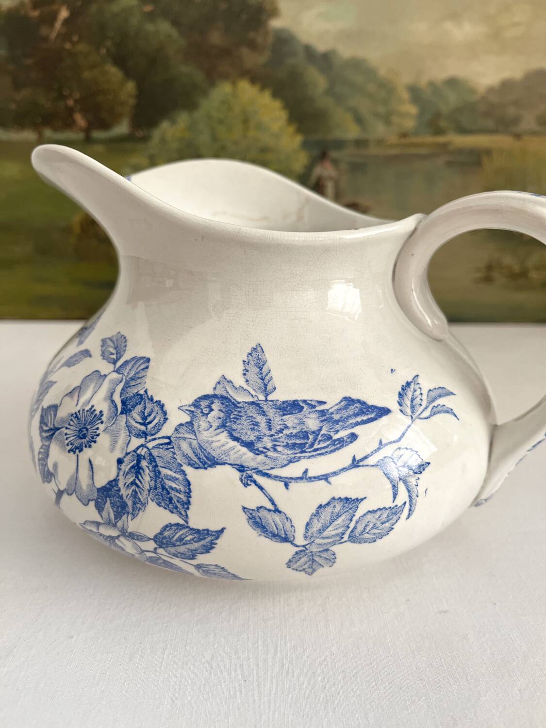 Antique chubby ironstone jug with floral and bird decoration