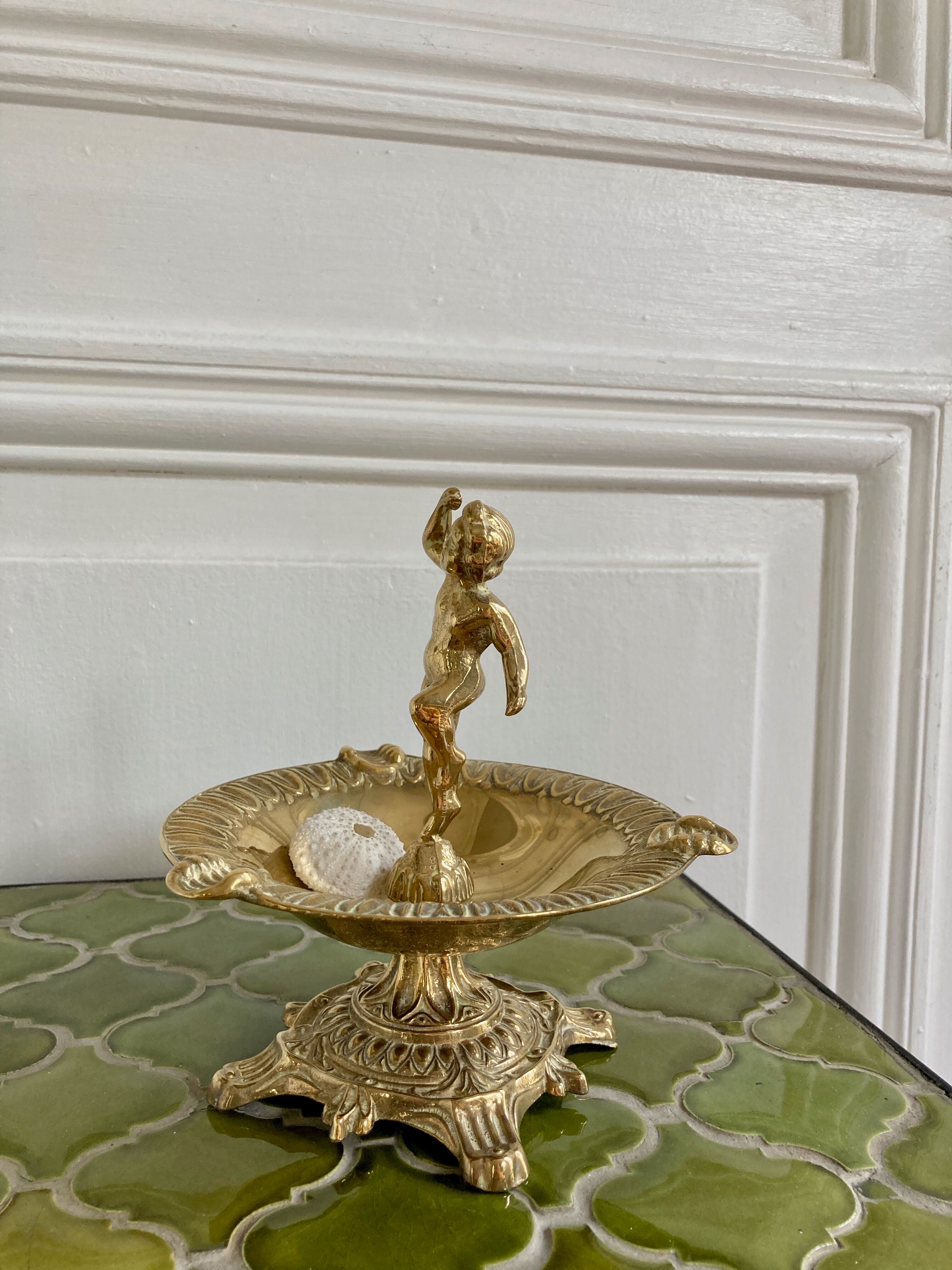 Brass cherub pocket-empty ashtray