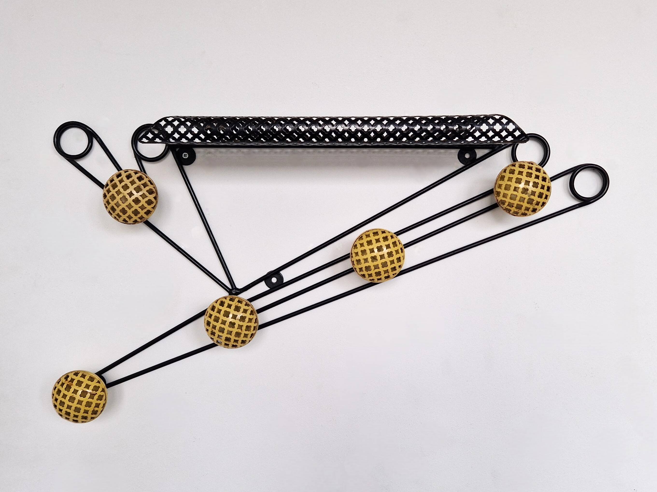 Black and yellow wall coat rack, France