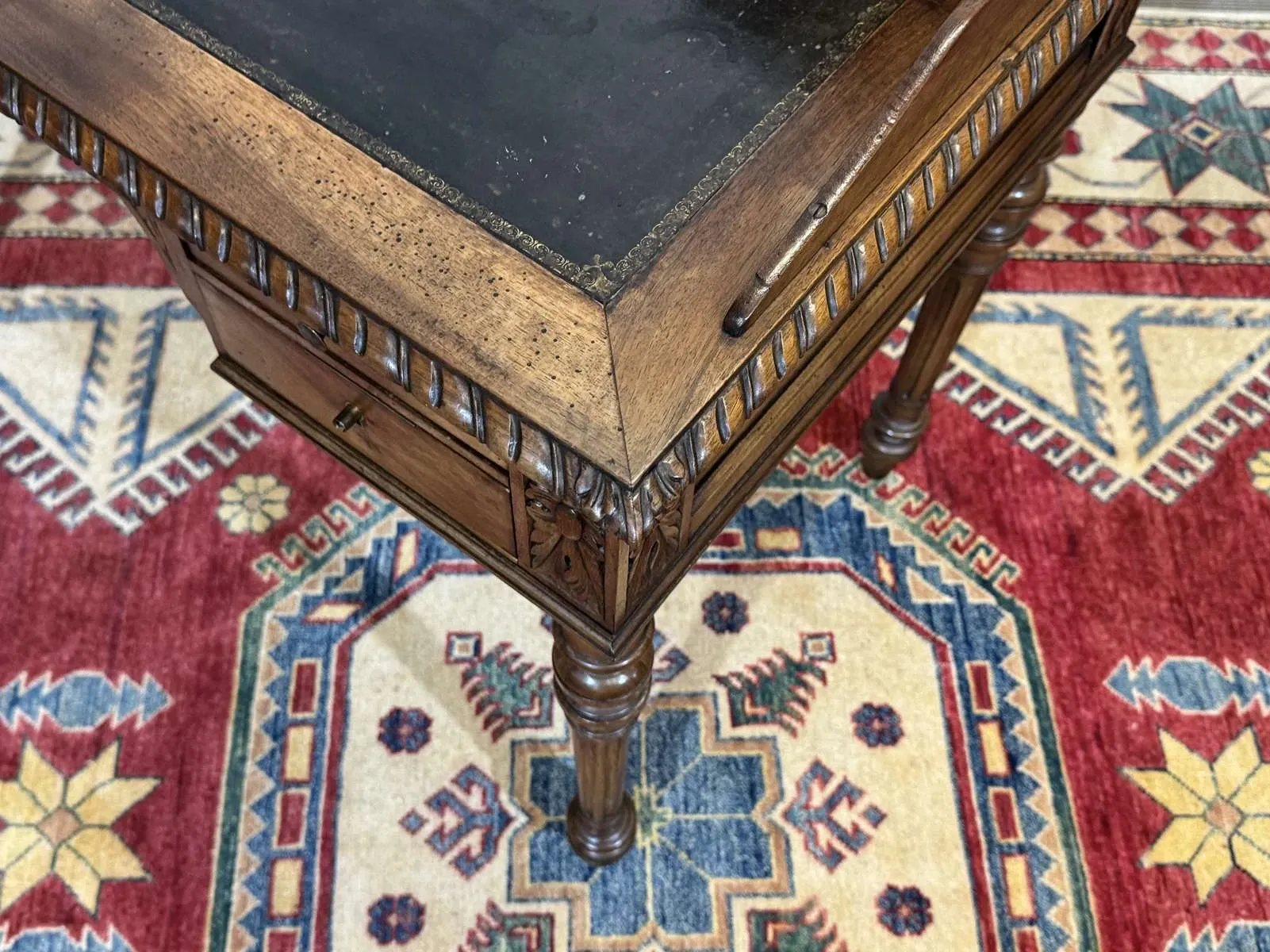 Louis XVI style desk from the late 19th century in walnut with a leather top.