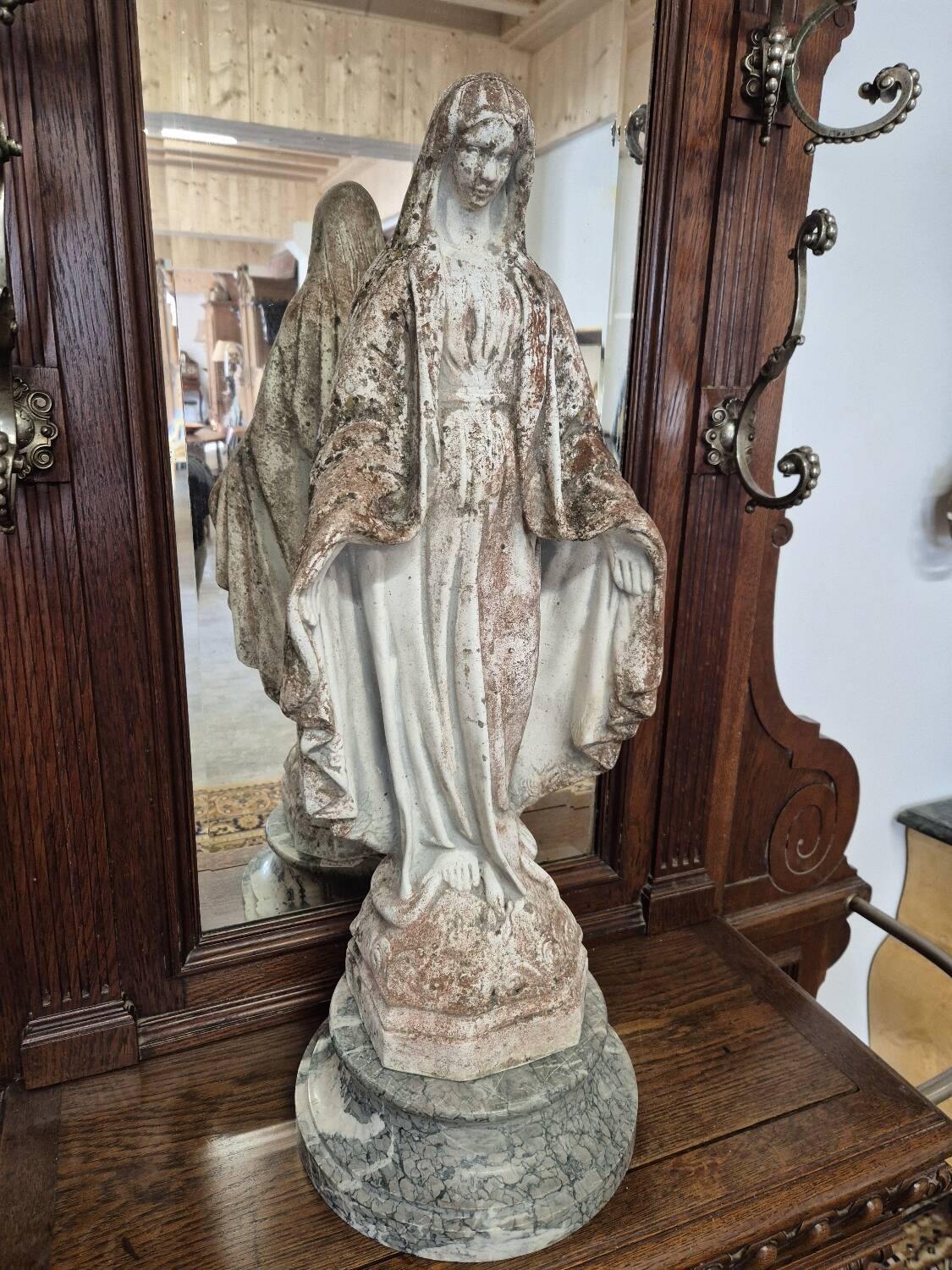 Garden statue of the Virgin Mary in old reconstituted stone