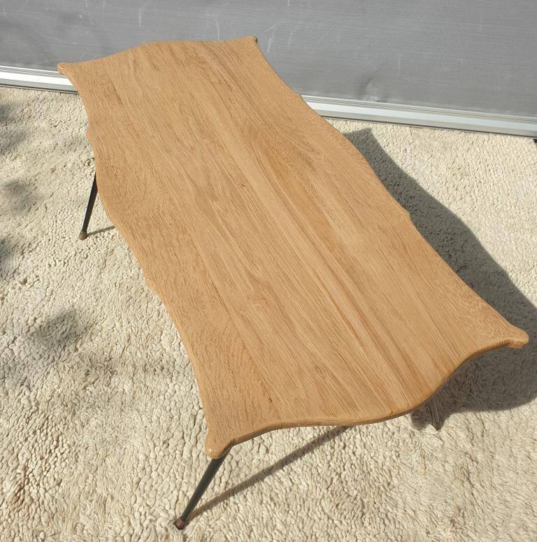 Violin-shaped coffee table with brass legs