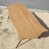 Violin-shaped coffee table with brass legs