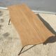 Violin-shaped coffee table with brass legs