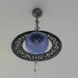 Patinated metal chandelier with cobalt blue blown glass in a rustic style.