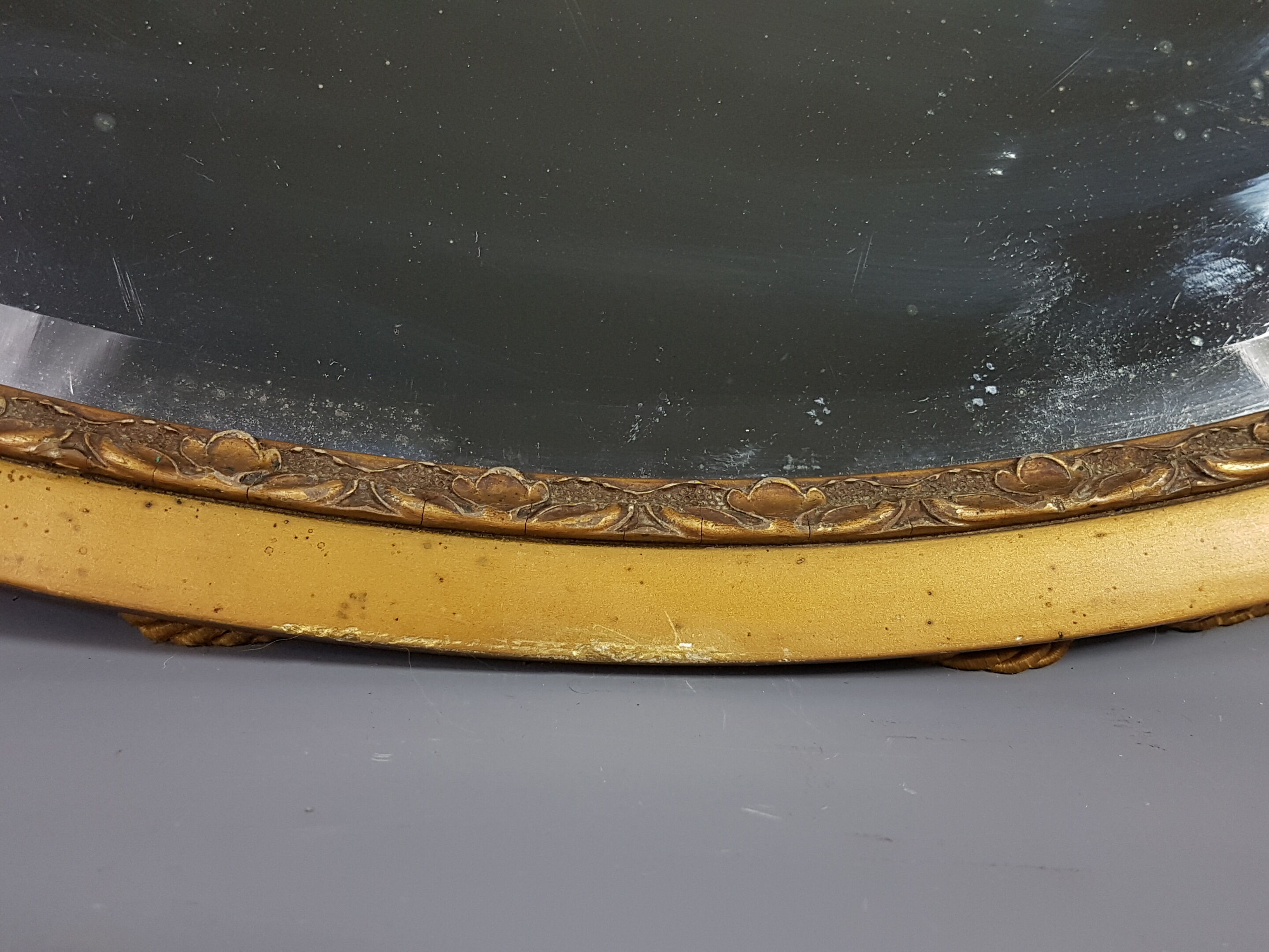 Old bevelled oval mirror with cord and pompoms, 60 x 36 cm