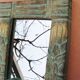 Petit miroir en bois sculpté à patine verte et dorée