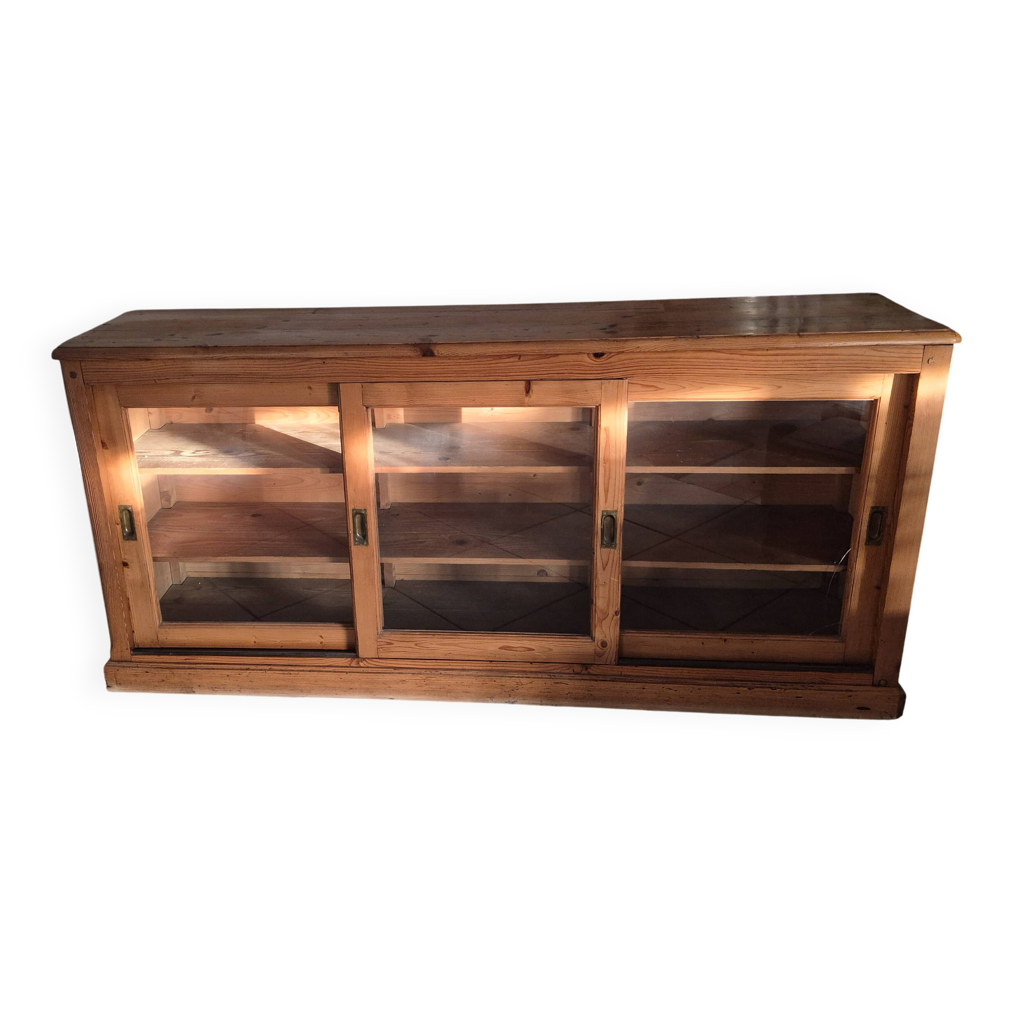 Antique wooden sideboard with three sliding glass doors.