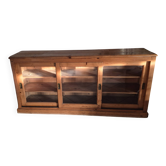 Antique wooden sideboard with three sliding glass doors.