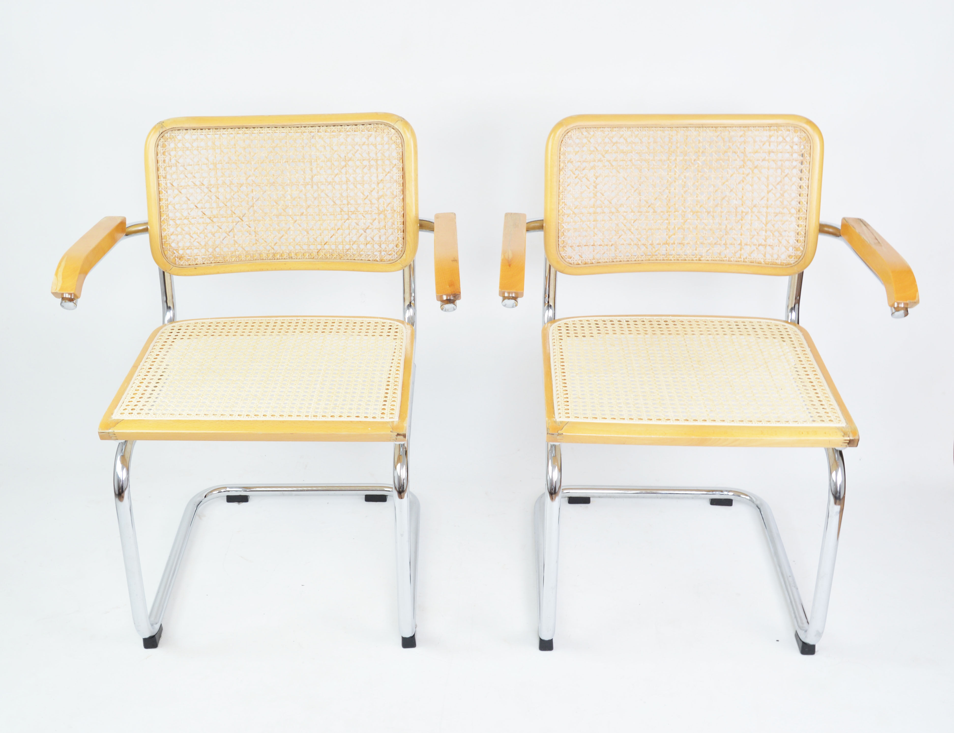 A pair of chairs with armrests, 1970s