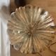 Table lamp with a golden striated globe and a golden base
