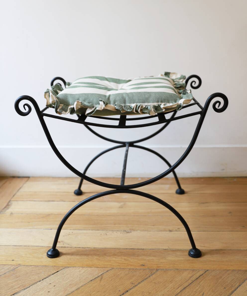pair of wrought iron stools with cushions