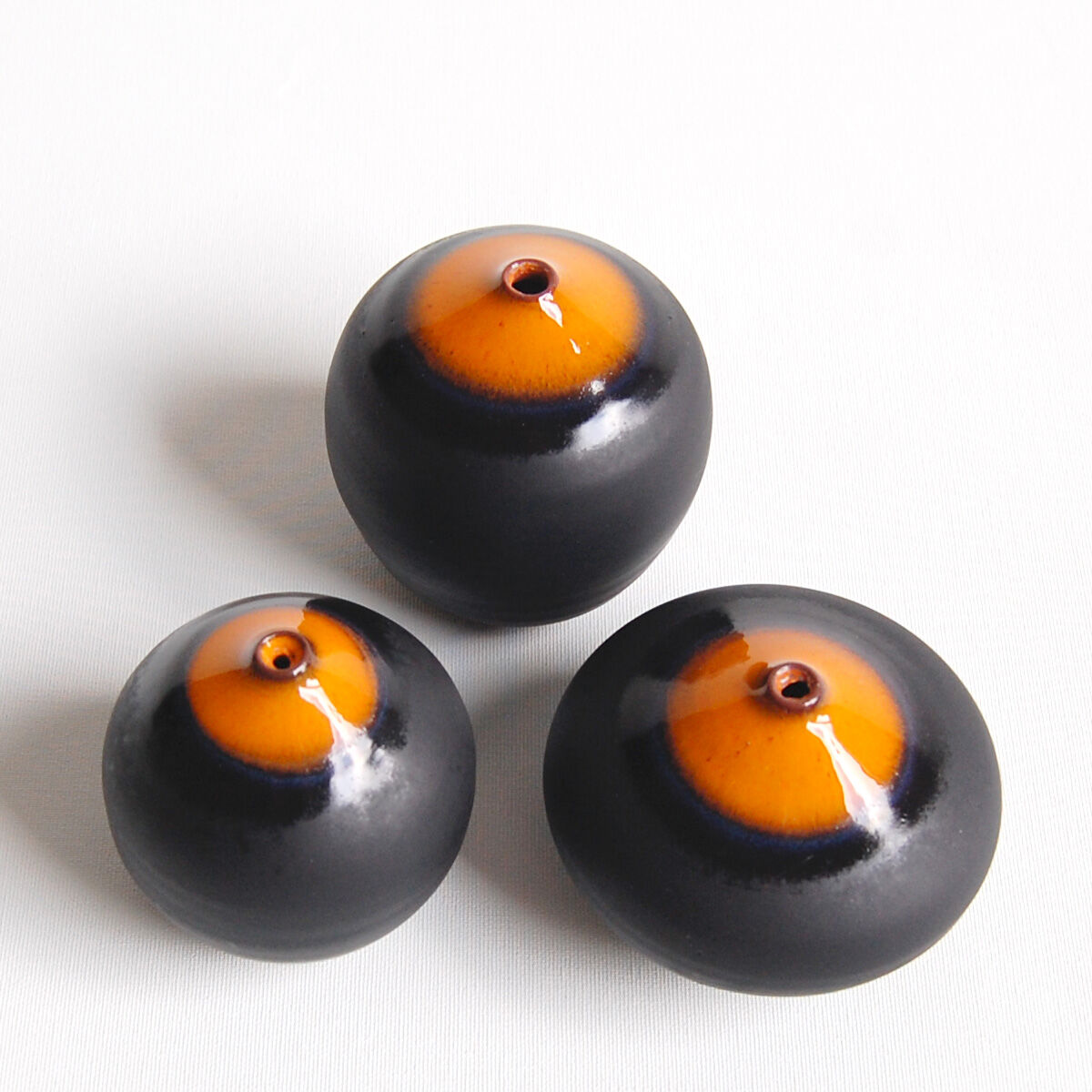 Trio of miniature black and orange ceramics Antonio Lampecco