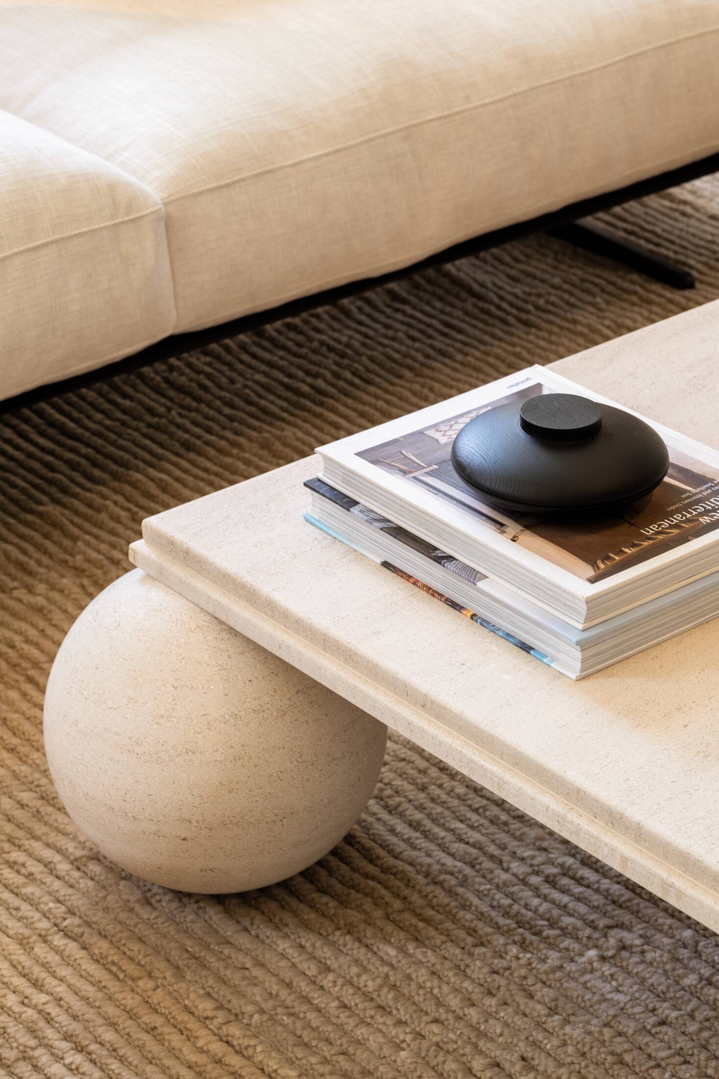 Square stone coffee table with sculptural ball legs