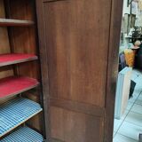 Bonnetière man standing cabinet a door