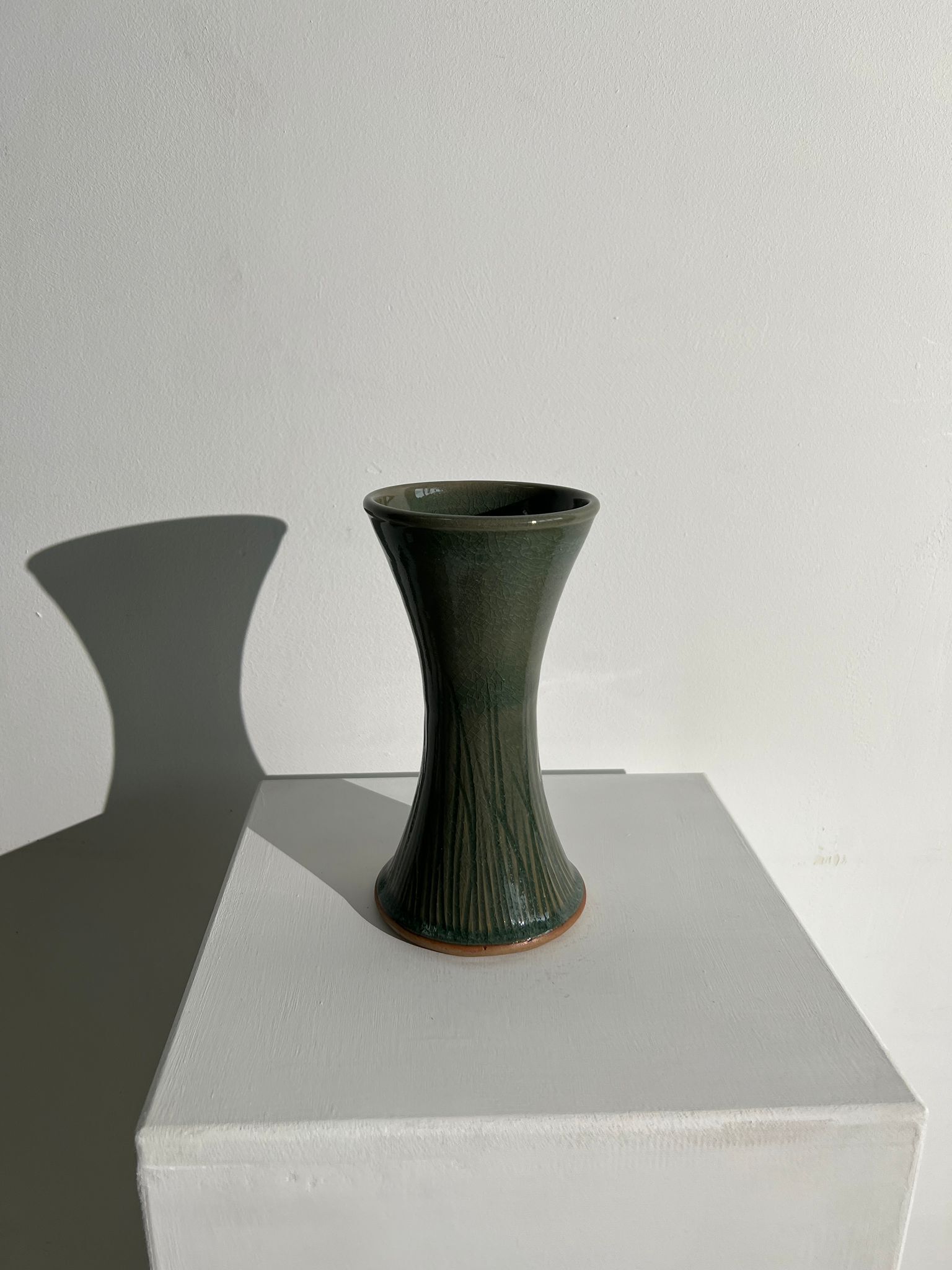 Dark green handcrafted vase with glazed ceramic grass blades