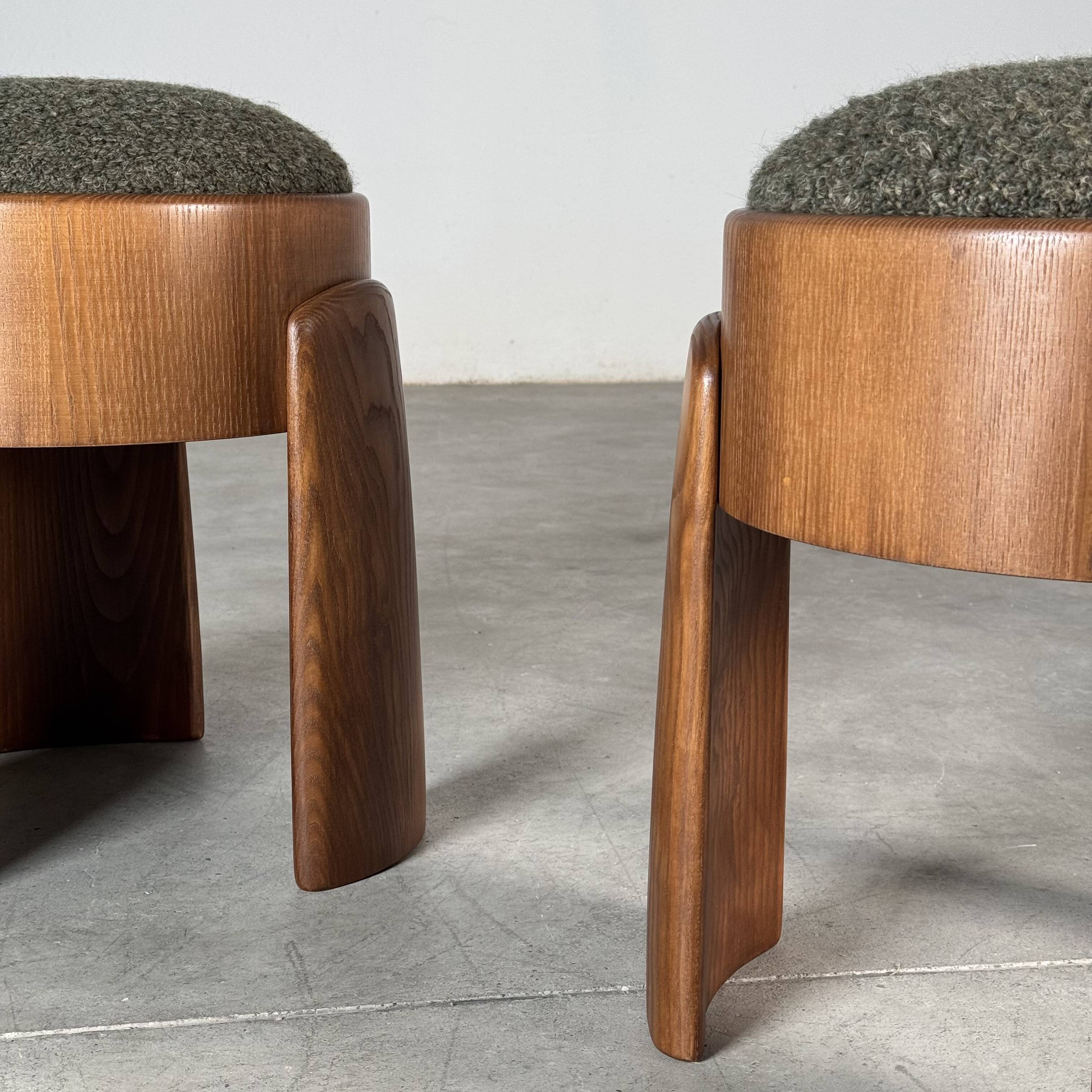 Sculptural pair of ash wood stools with dedar milano bouclé